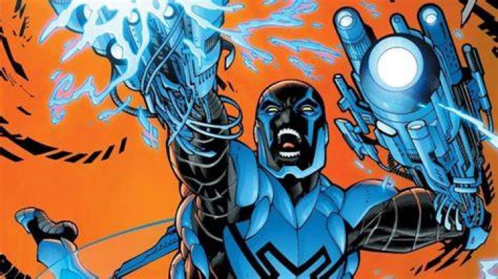 Blue Beetle firing his arm blaster