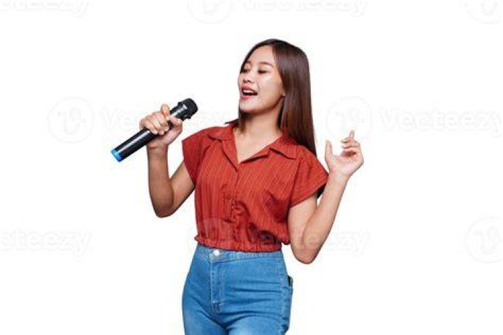 Haruhi singing into microphone holding a guitar