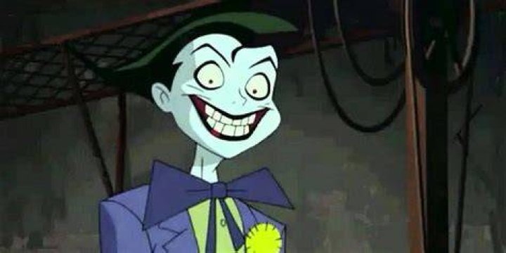 The Joker (Tim Drake) grins malevolently and raises his arms in Batman Beyond: Return of the Joker