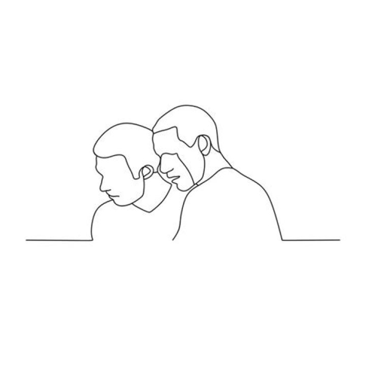 Two men are looking down at something on The Platform.